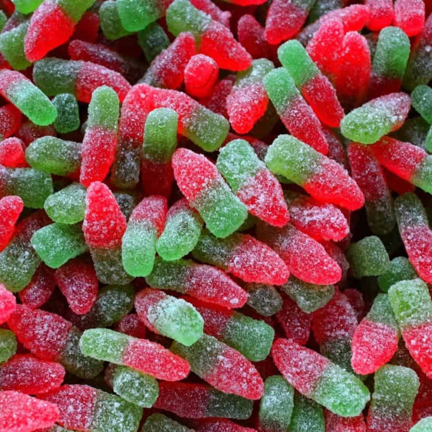 Close-up of red and green gummy bottles
