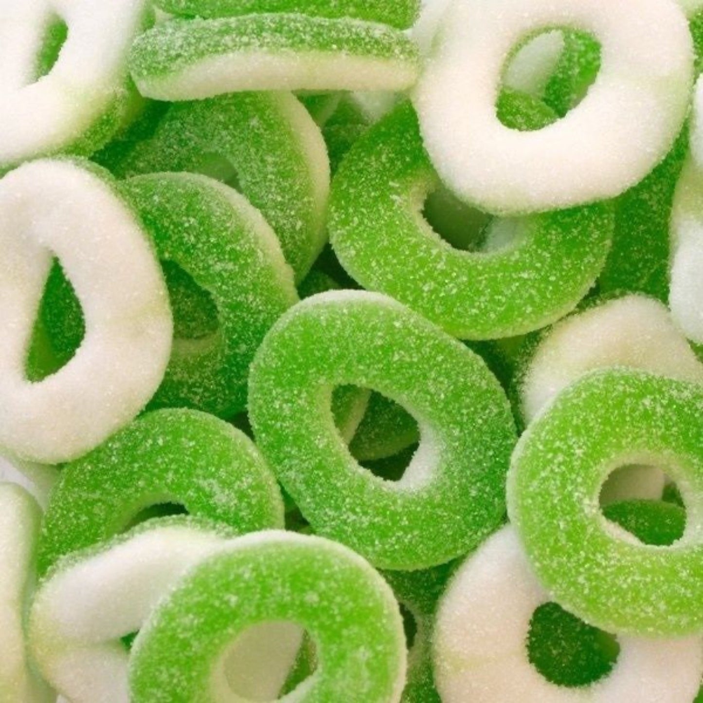 Close-up of green and white gummy candy rings.