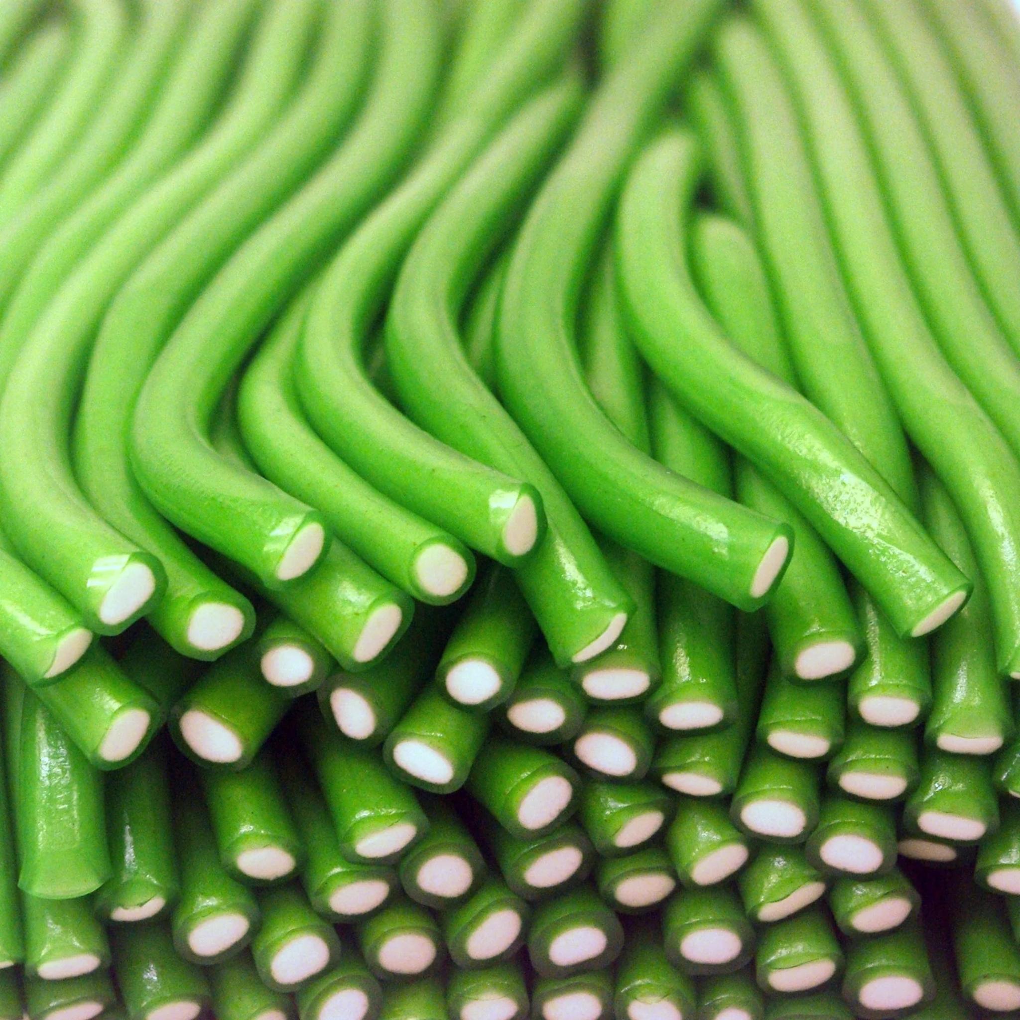 Close-up of green licorice sticks with white spots
