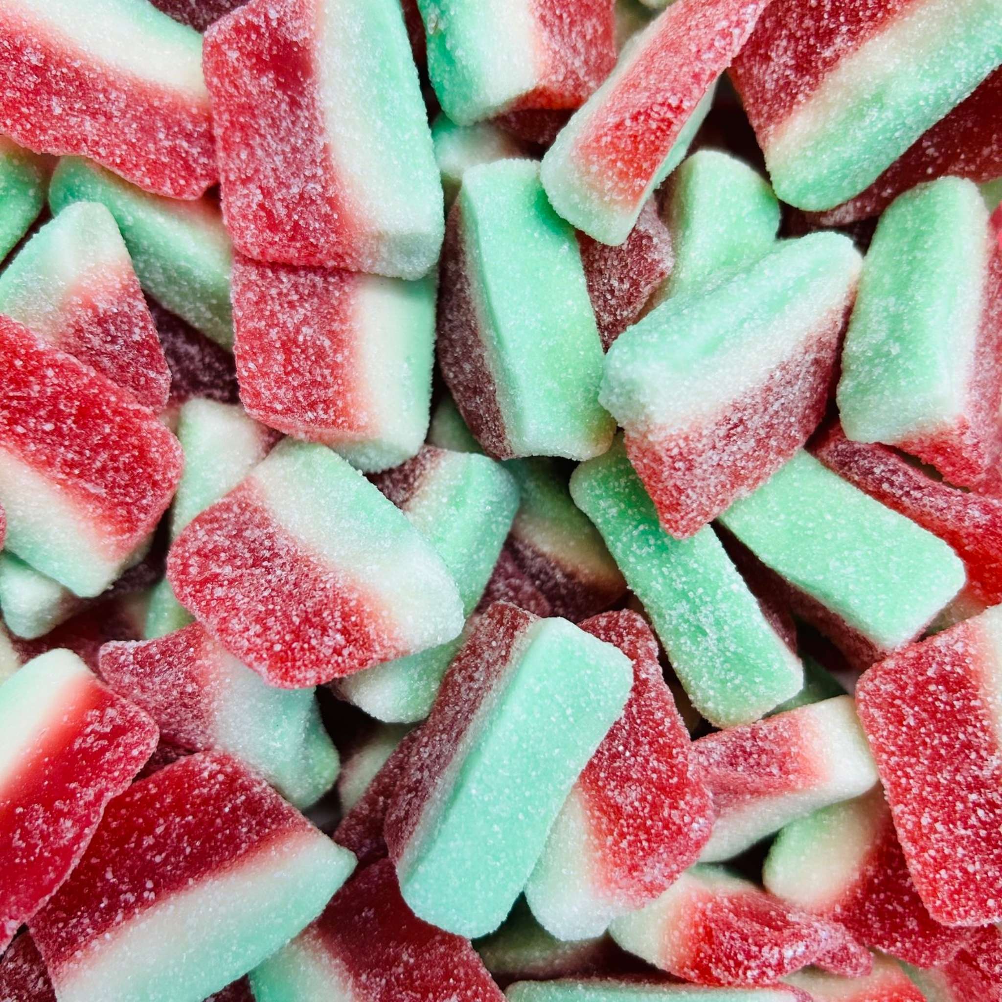 Close-up of red and green gummy candy pieces.